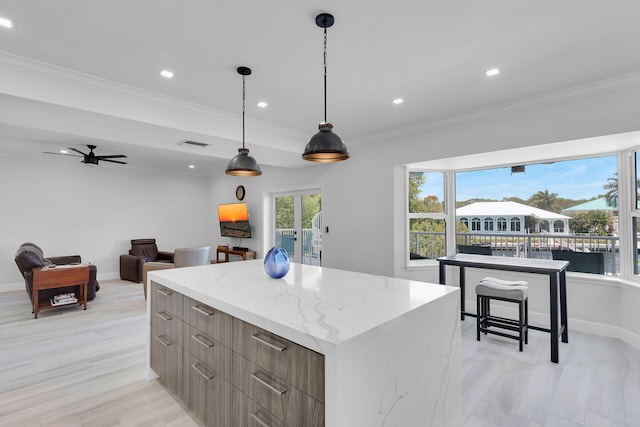 kitchen with modern cabinets, crown molding, light wood finished floors, a center island, and recessed lighting