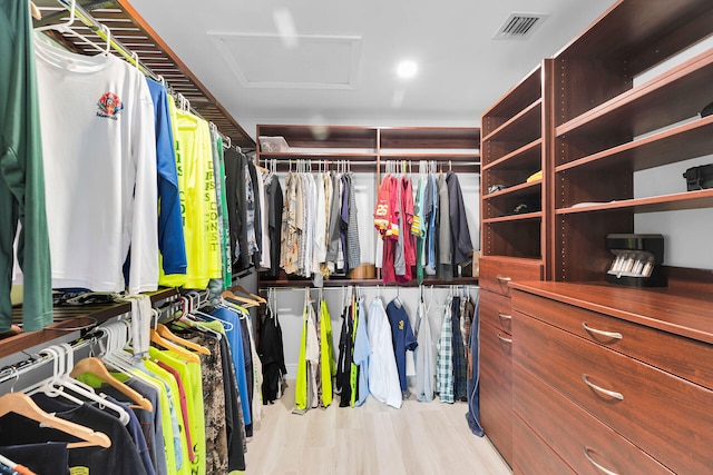 walk in closet featuring attic access