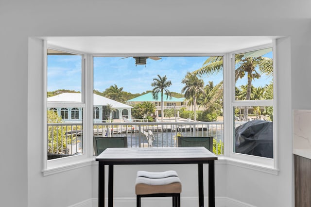 sunroom / solarium featuring a water view and plenty of natural light