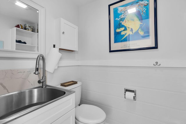 bathroom featuring toilet and vanity