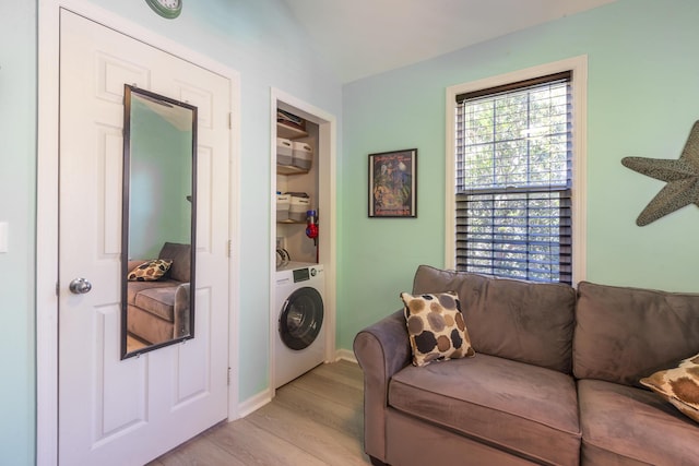 living room with washer / clothes dryer and light wood finished floors