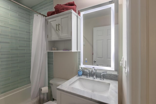 bathroom with vanity, shower / tub combo, and toilet