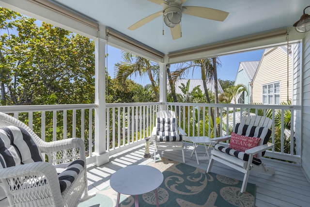 sunroom / solarium with a ceiling fan