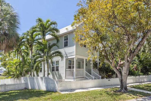 view of front of home with a porch and a fenced front yard