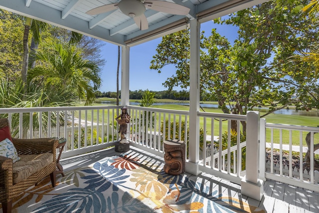 wooden terrace featuring a water view and ceiling fan