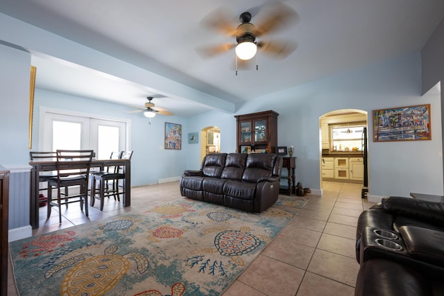 tiled living room with ceiling fan