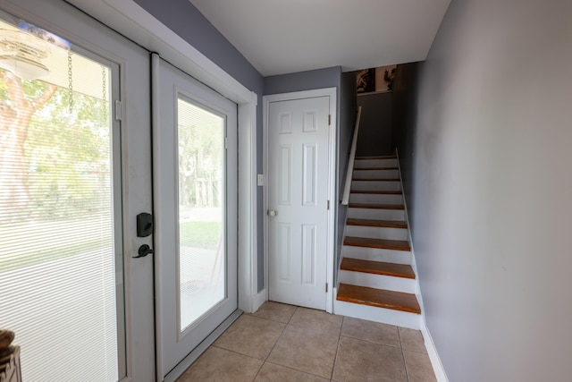 entryway featuring light tile patterned floors and french doors