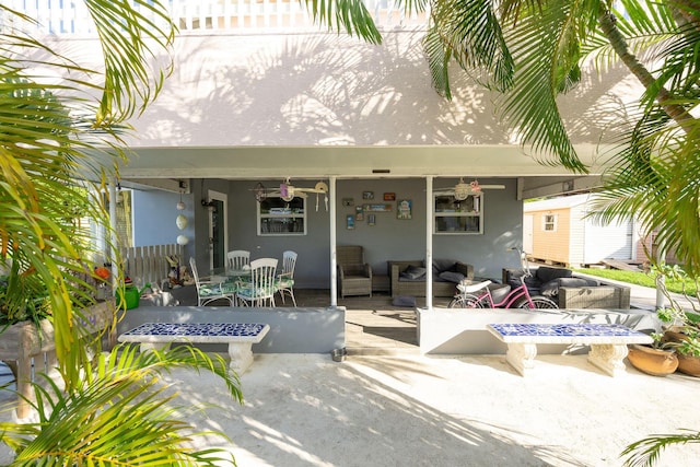 exterior space with a patio and an outdoor living space with a fire pit