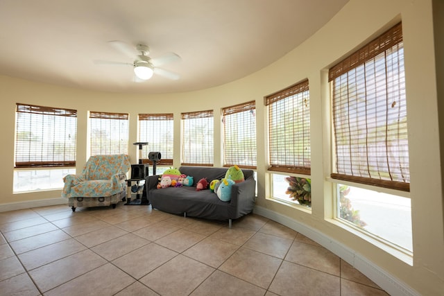 sunroom / solarium featuring ceiling fan