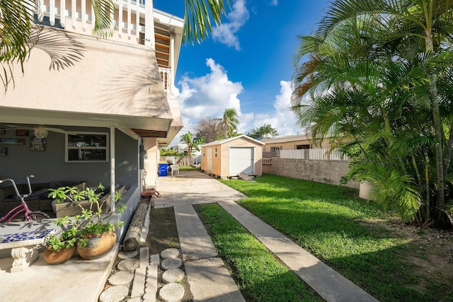 view of yard featuring a storage shed and a patio area