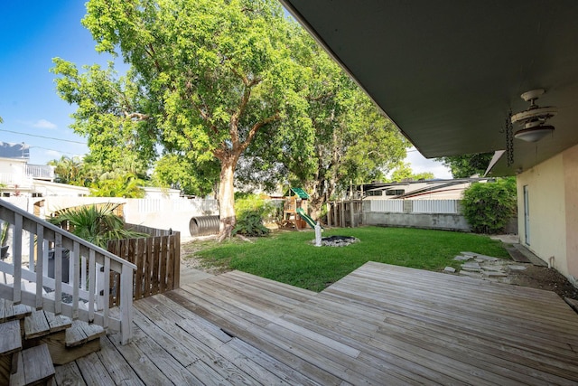 deck with a playground and a yard