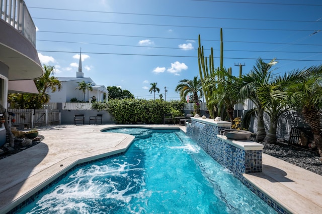 view of swimming pool with a patio and pool water feature