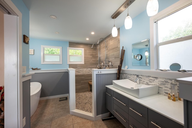 bathroom featuring tasteful backsplash, vanity, tile patterned floors, and tiled shower