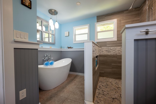 bathroom with radiator, tile patterned floors, and plus walk in shower