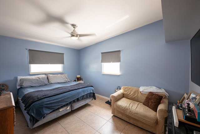 bedroom with multiple windows, light tile patterned floors, and ceiling fan