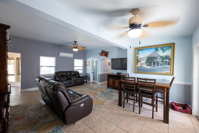 tiled living room with ceiling fan and a wall mounted air conditioner