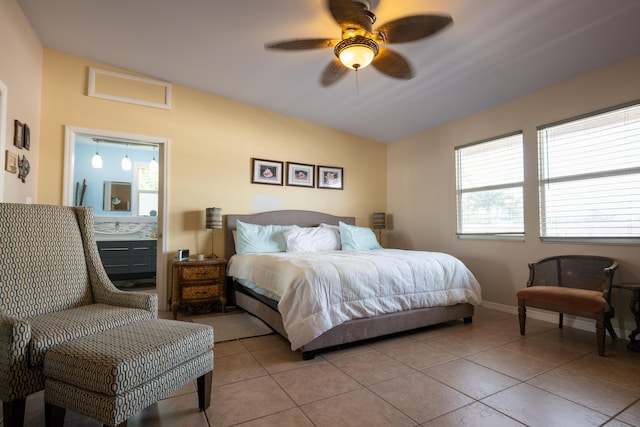 tiled bedroom with ceiling fan, lofted ceiling, and ensuite bath