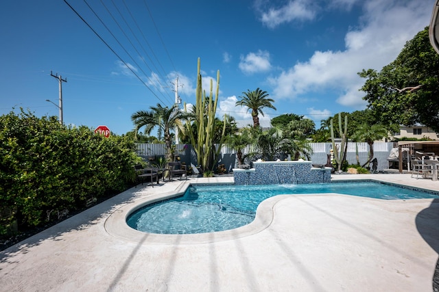 view of pool with pool water feature and a patio area