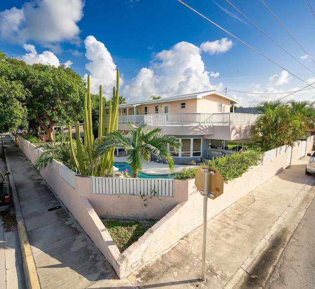 view of front facade with a fenced in pool