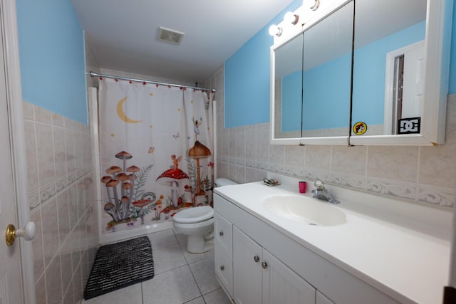 full bathroom with toilet, shower / tub combo, tile walls, vanity, and tile patterned flooring