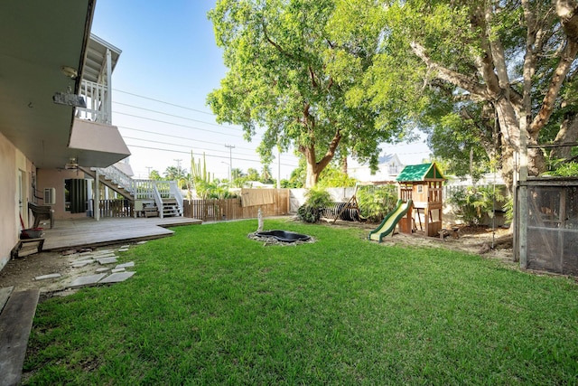 view of yard featuring a wooden deck and a playground