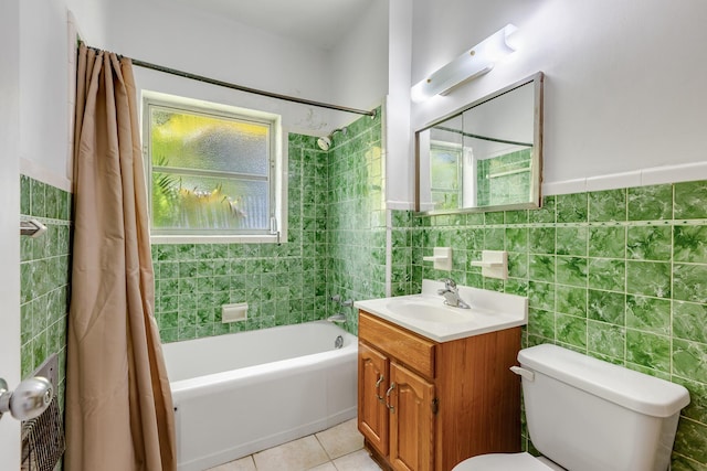 full bath featuring toilet, tile patterned floors, tile walls, and shower / tub combo with curtain