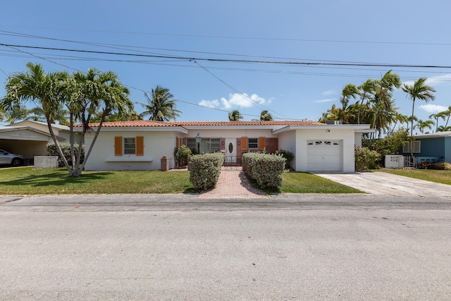 single story home with a tiled roof, an attached garage, driveway, and stucco siding