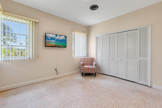 unfurnished room featuring baseboards and visible vents
