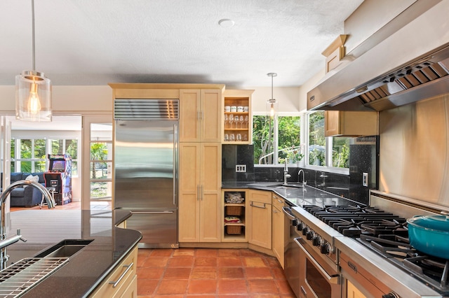 7563 Gulfstream Blvd, Marathon, FL 33050 - kitchen with high end appliances, wall chimney exhaust hood, a sink, open shelves, and healthy amount of natural light