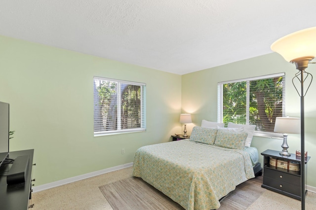 7563 Gulfstream Blvd, Marathon, FL 33050 - bedroom with multiple windows, baseboards, a textured ceiling, and speckled floor