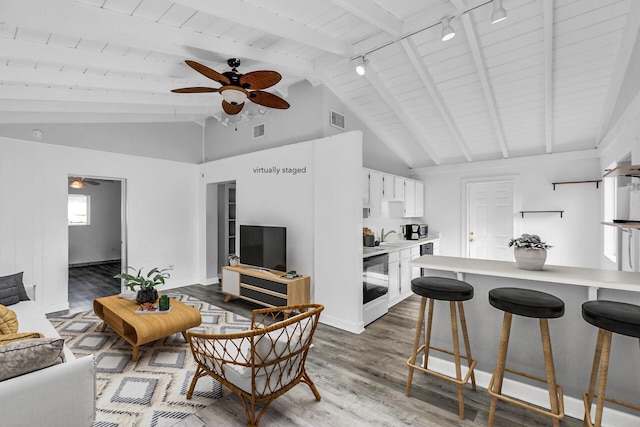 living room with wood ceiling, hardwood / wood-style flooring, rail lighting, ceiling fan, and lofted ceiling with beams