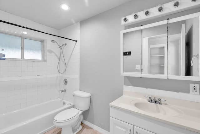 full bathroom with vanity, tiled shower / bath, and toilet