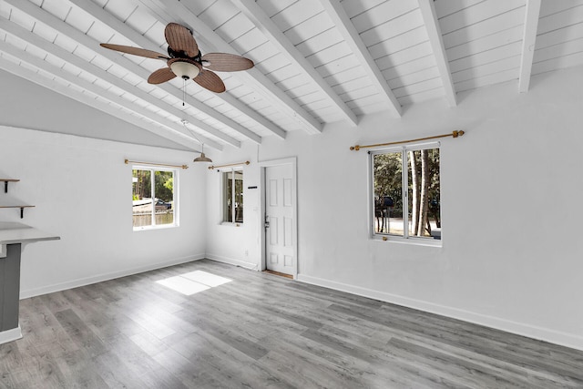 unfurnished living room with lofted ceiling with beams, ceiling fan, hardwood / wood-style flooring, and wood ceiling