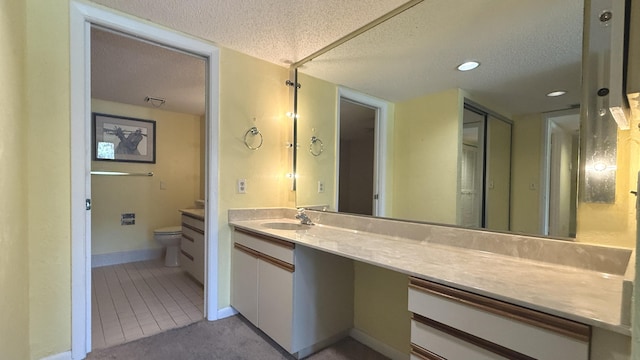 1800 Atlantic Blvd Unit C130, Key West, FL 33040 - bathroom featuring a textured ceiling, toilet, vanity, tile patterned flooring, and recessed lighting