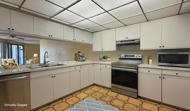 1800 Atlantic Blvd Unit C130, Key West, FL 33040 - kitchen with stainless steel appliances, a sink, under cabinet range hood, and light countertops