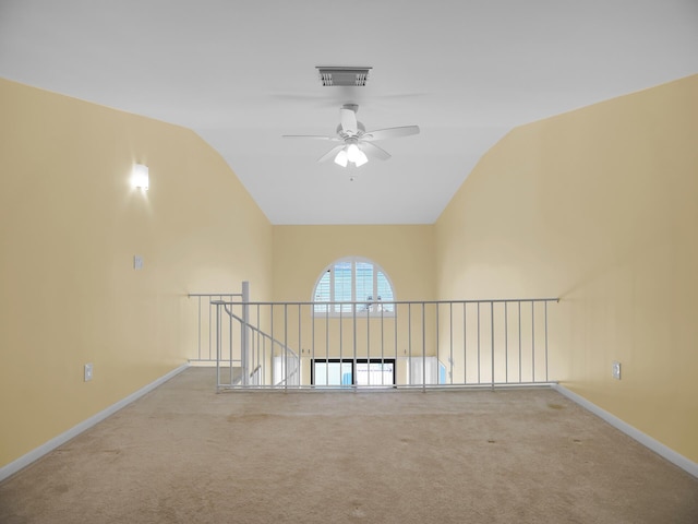 carpeted empty room featuring lofted ceiling and ceiling fan