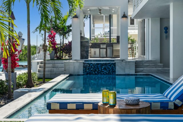 view of swimming pool featuring a jacuzzi