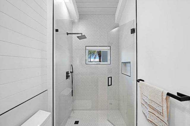 bathroom featuring a shower with door