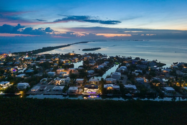 aerial view at dusk with a water view