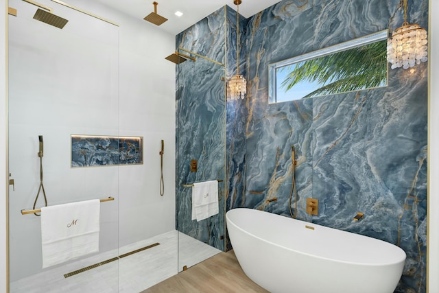 bathroom featuring hardwood / wood-style flooring and plus walk in shower