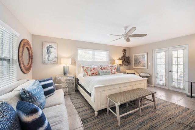 tiled bedroom featuring multiple windows, access to outside, ceiling fan, and french doors