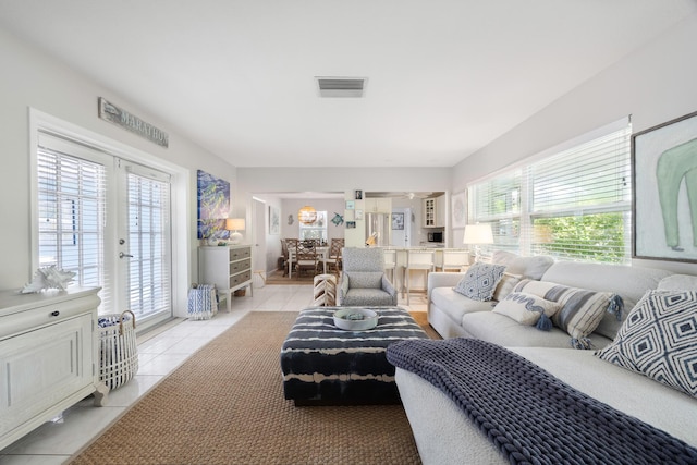 tiled living room featuring french doors