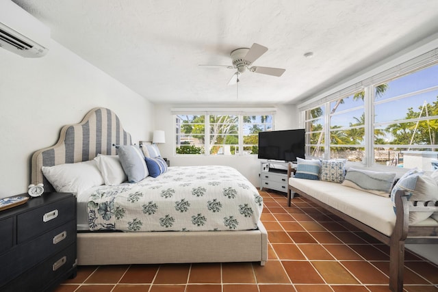 tiled bedroom with ceiling fan, a textured ceiling, and an AC wall unit