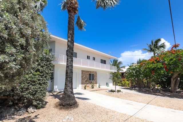 321 Calzada De Bougainville, Marathon, FL 33050 - view of front of home with a balcony, stucco siding, and stone siding