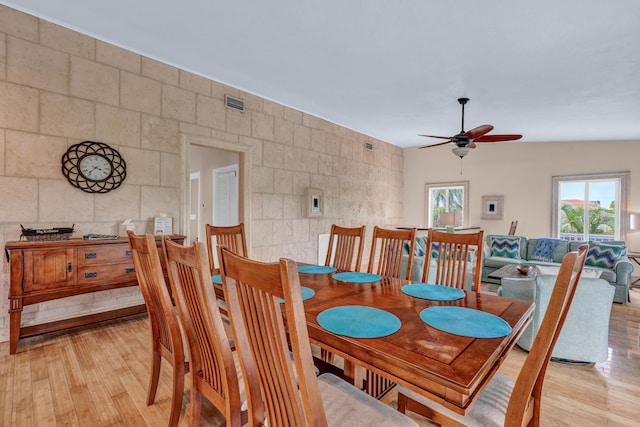 321 Calzada De Bougainville, Marathon, FL 33050 - dining space featuring a ceiling fan, light wood-style flooring, and tile walls