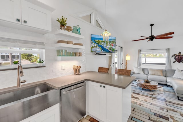 kitchen with sink, dishwasher, tasteful backsplash, white cabinets, and kitchen peninsula