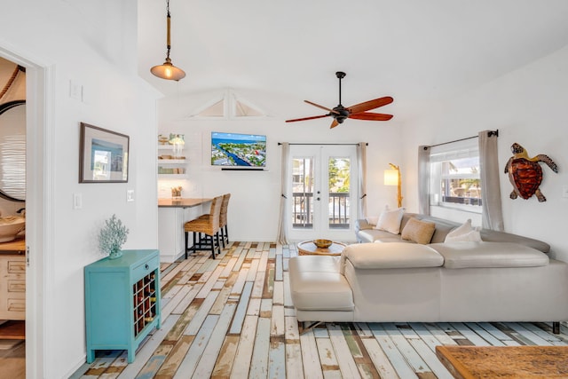 living room with ceiling fan, plenty of natural light, light wood-type flooring, and french doors