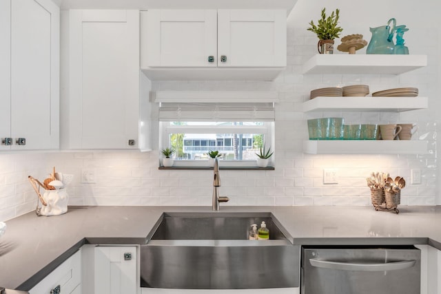 kitchen with sink, backsplash, dishwasher, and white cabinets