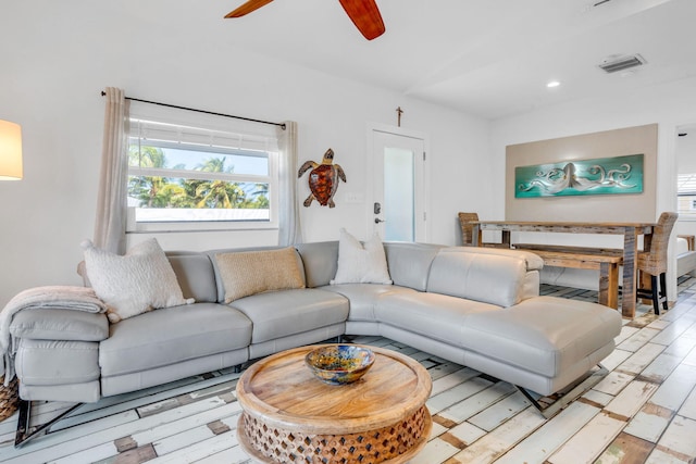 living room featuring ceiling fan and light wood-type flooring