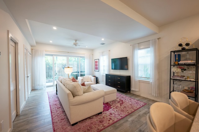 living room with baseboards, hardwood / wood-style floors, a ceiling fan, and recessed lighting